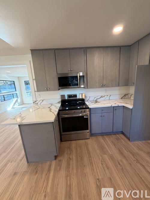 A kitchen with a stove top oven and a microwave.