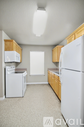 A spacious room with a ceiling fan and carpeted floor.