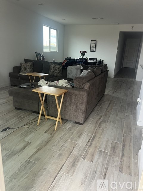 A living room with a grey couch and wooden coffee table.