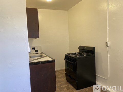 A kitchen area with a black oven and a counter with a sink.
