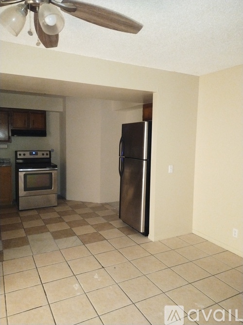 A kitchen with a refrigerator, oven, and microwave.