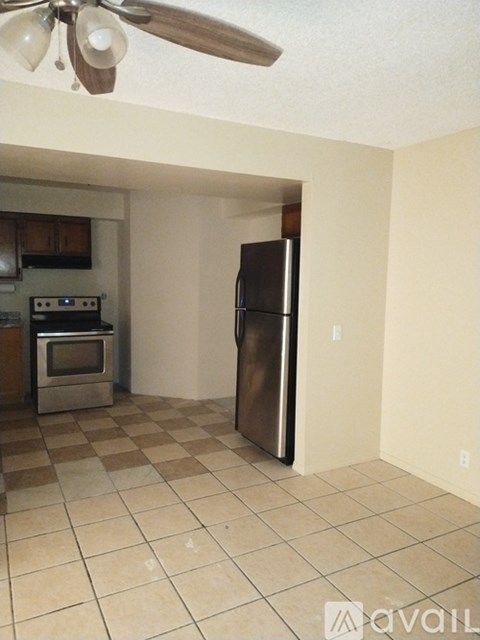 A kitchen with a refrigerator, oven, and microwave.