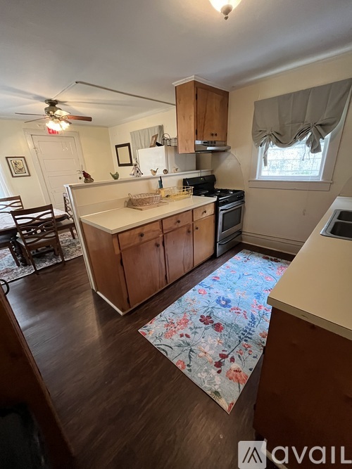 A kitchen with wooden cabinets and a white countertop.