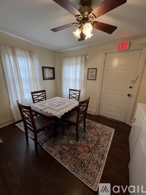 A dining room with a table and chairs.