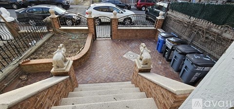 A small garden with a statue and steps.