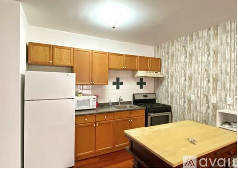 A kitchen with wooden cabinets and a white refrigerator.