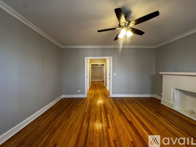 A room with wooden floors and two windows.