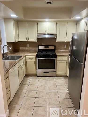 A kitchen with a stove, oven, and refrigerator.