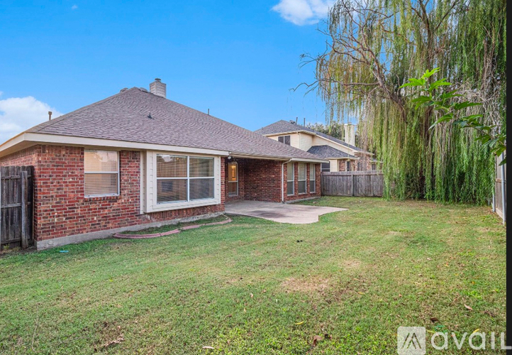 A house with a brick exterior and a large yard.