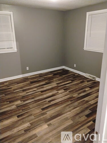 A room with a dark brown wall and a white door.
