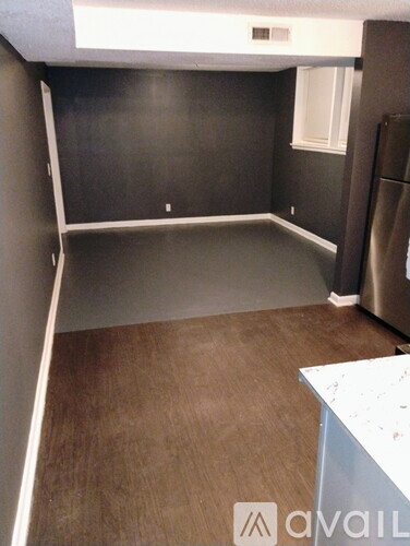A kitchen with a refrigerator and a counter.