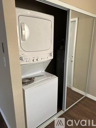 A white dishwasher is built into a kitchen cabinet.