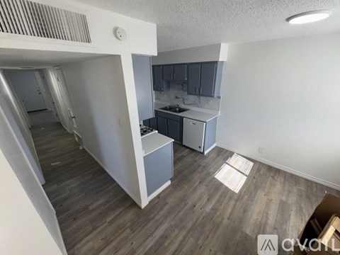 A kitchen area with a sink and cabinets.