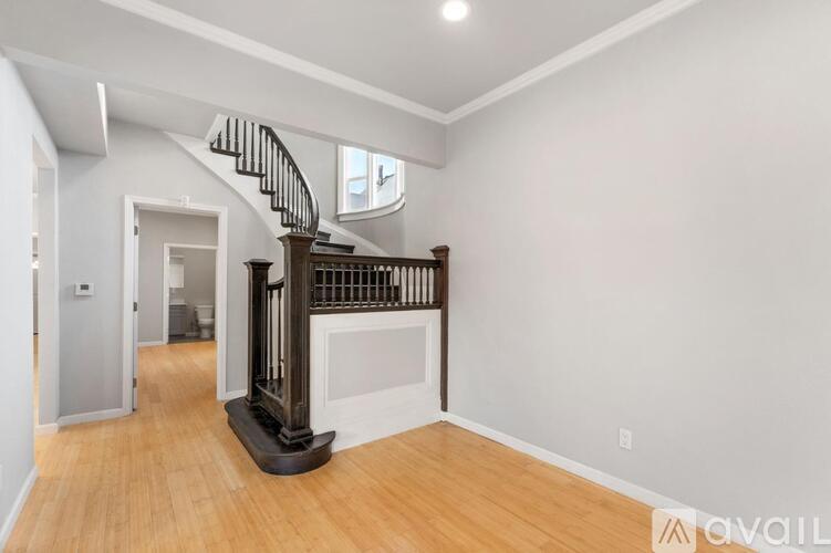 A living room with a spiral staircase in the middle.
