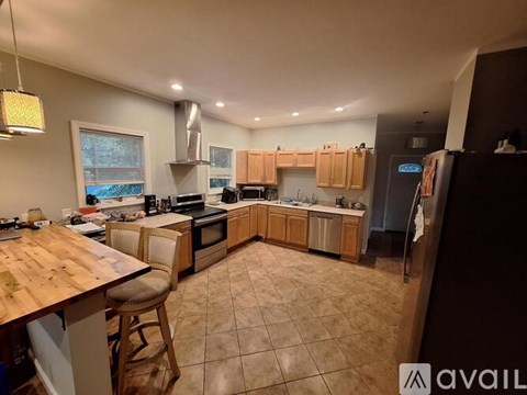 A kitchen with wooden countertops and a large island.