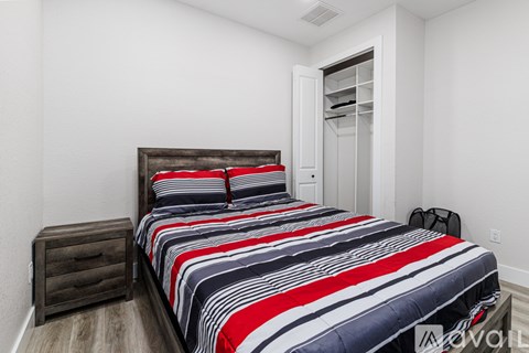 A bedroom with a bed, a dresser, and a ROKU sign on the wall.