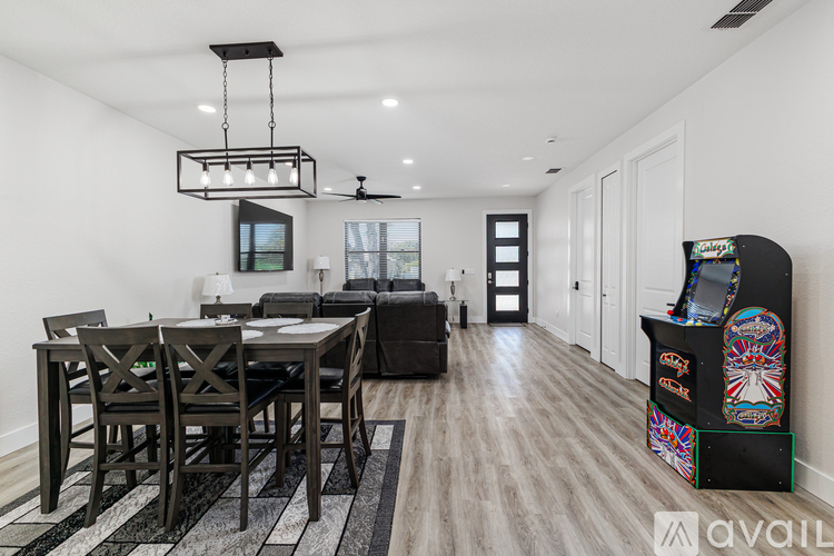 A modern dining room with a black table and chairs.