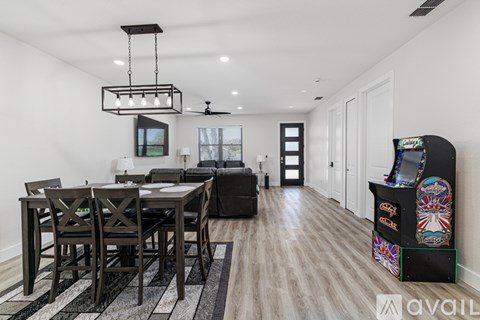 A modern dining room with a black table and chairs.