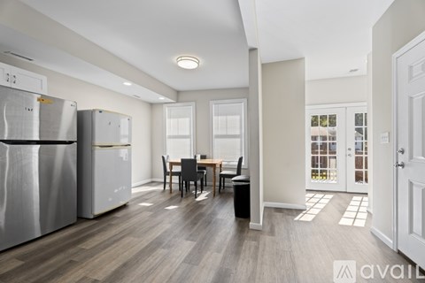 A kitchen with a table and chairs in the middle of the room.