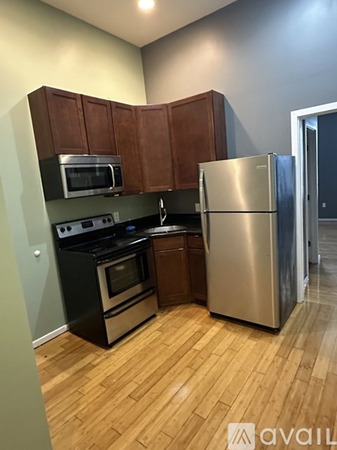 A kitchen with wooden cabinets and stainless steel appliances.