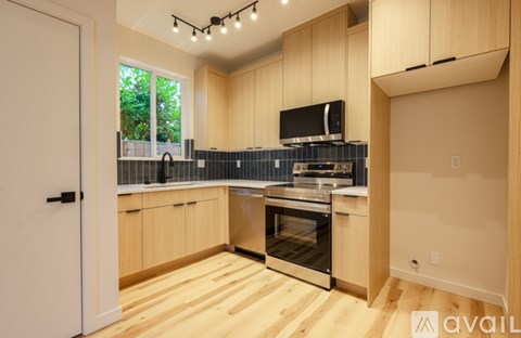 A kitchen with wooden cabinets and a stainless steel oven.