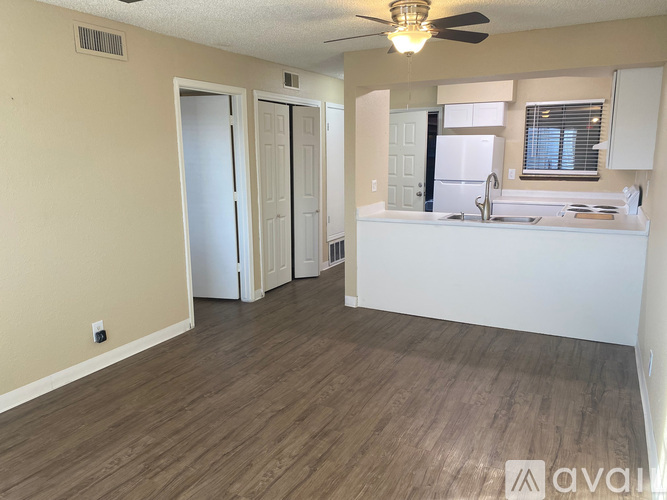 A hallway with a washer and dryer in a home.