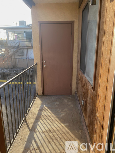 A balcony of a building with a door and a railing.