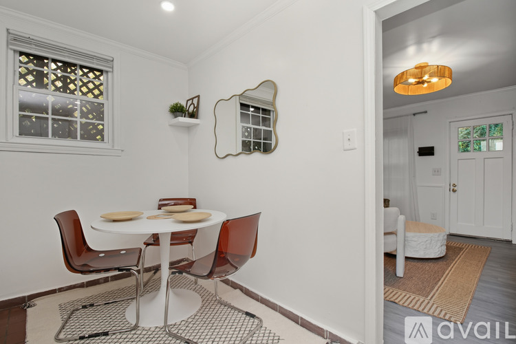 A kitchen with white cabinets and a black stove top oven.