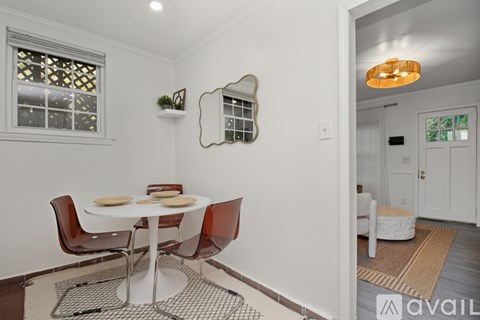 A kitchen with white cabinets and a black stove top oven.