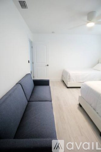 A living room with a couch and a bed.