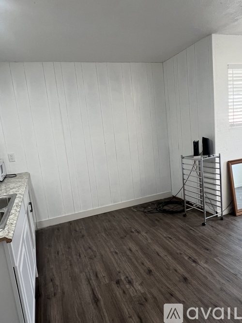 A room with wooden floors and white walls.