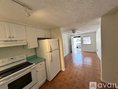 A small white washer and dryer in a narrow room.