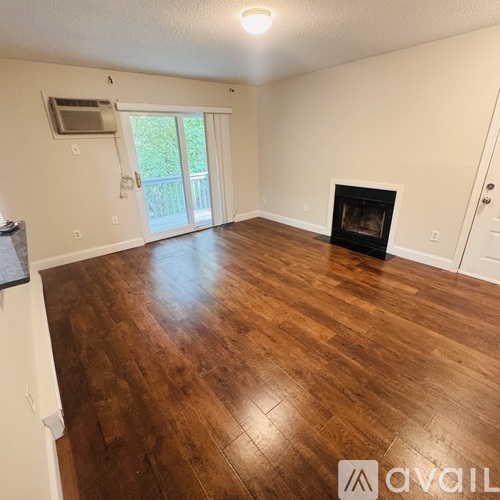A room with a fireplace and sliding glass doors.