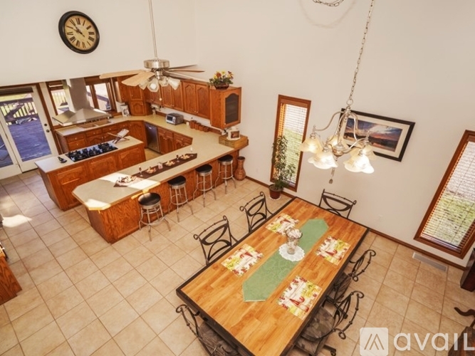 A dining room with a wooden table set for a meal.