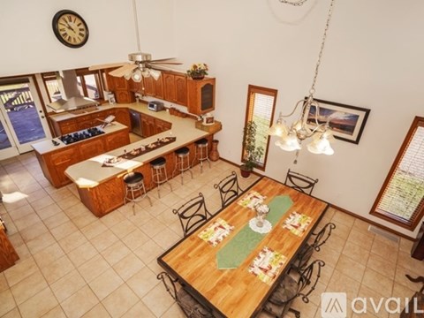 A dining room with a wooden table set for a meal.