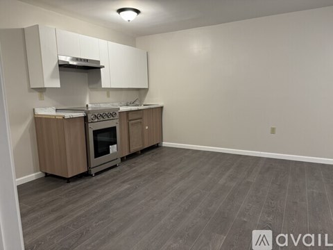 A kitchen with a stove top oven and a range hood.