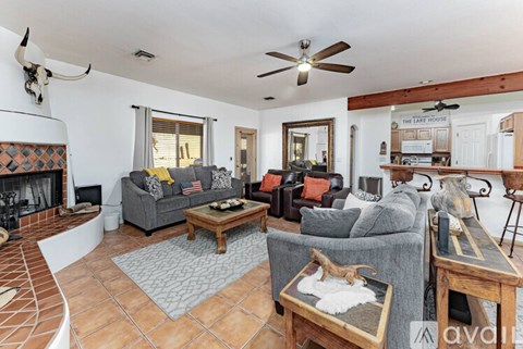 A living room with a grey couch and a wooden coffee table.