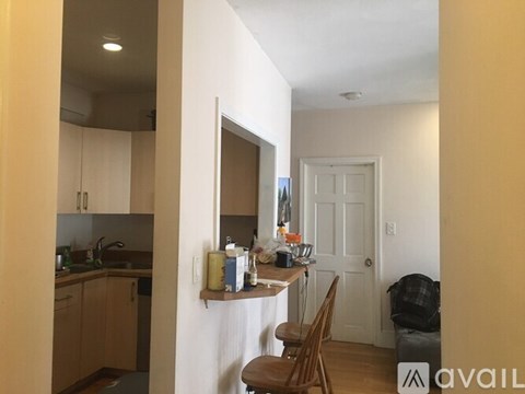 A kitchen with wooden cabinets and a white door.