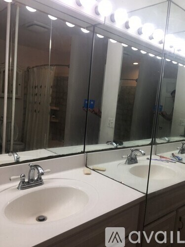 A bathroom with a sink and mirror.