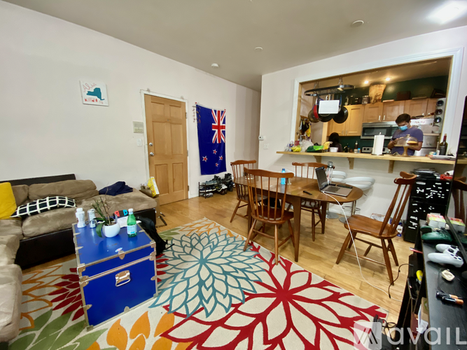 A living room with a blue suitcase on the rug.