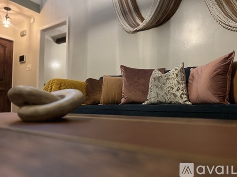 A living room with a couch and a large mirror on the wall.
