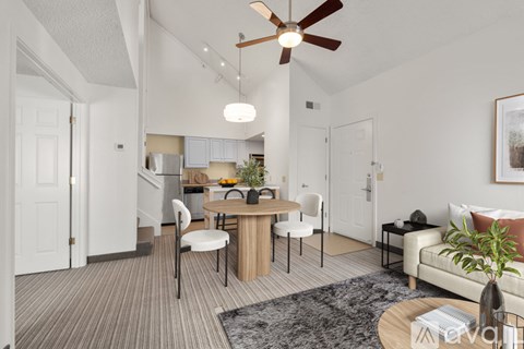 A living room with a dining table and chairs.