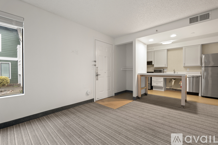 A kitchen area with a dining table and chairs in the middle of the room.