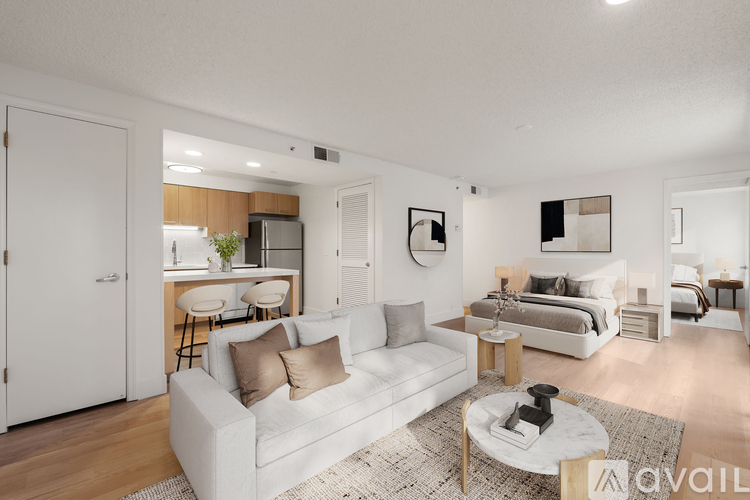 A modern living room with a white couch and a coffee table.