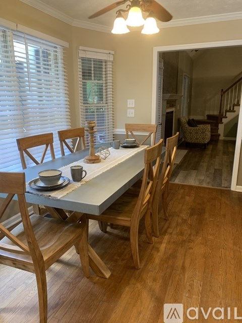 A dining room with a table and chairs.