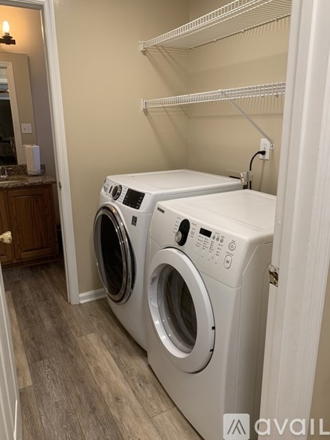 Two front load washing machines in a laundry room.