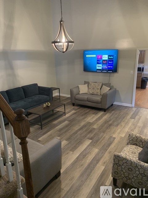 A living room with a television and a sofa.