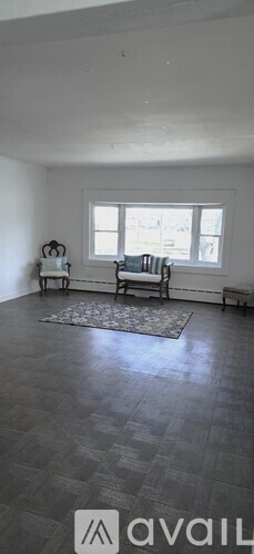 A room with a window and a bench.