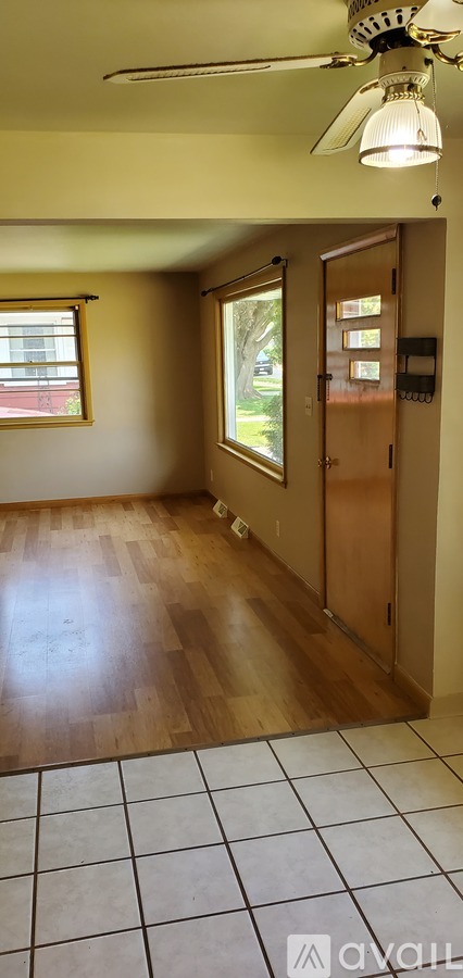 A room with a ceiling fan and a window.
