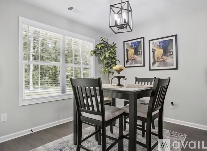 A dining room with a table and chairs.
